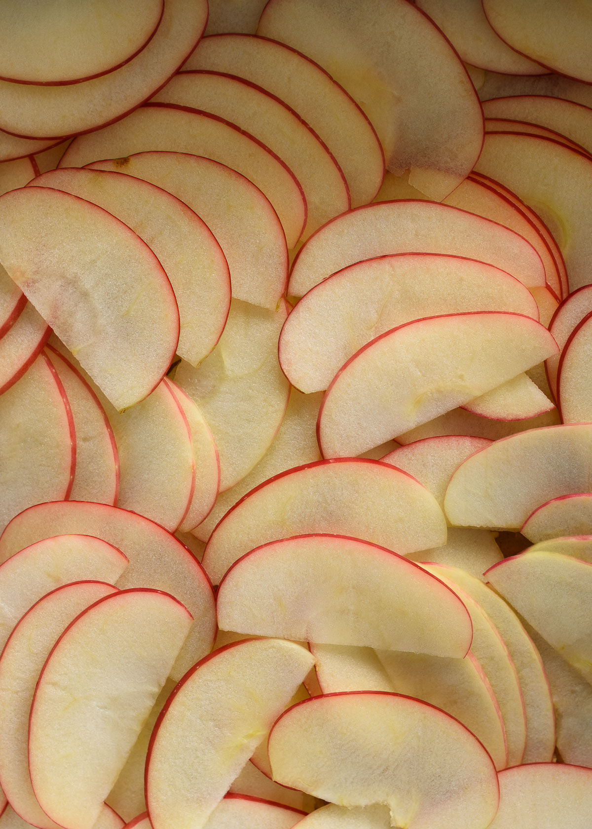 Layers of thinly sliced apples form the filling of apple crumb bars.