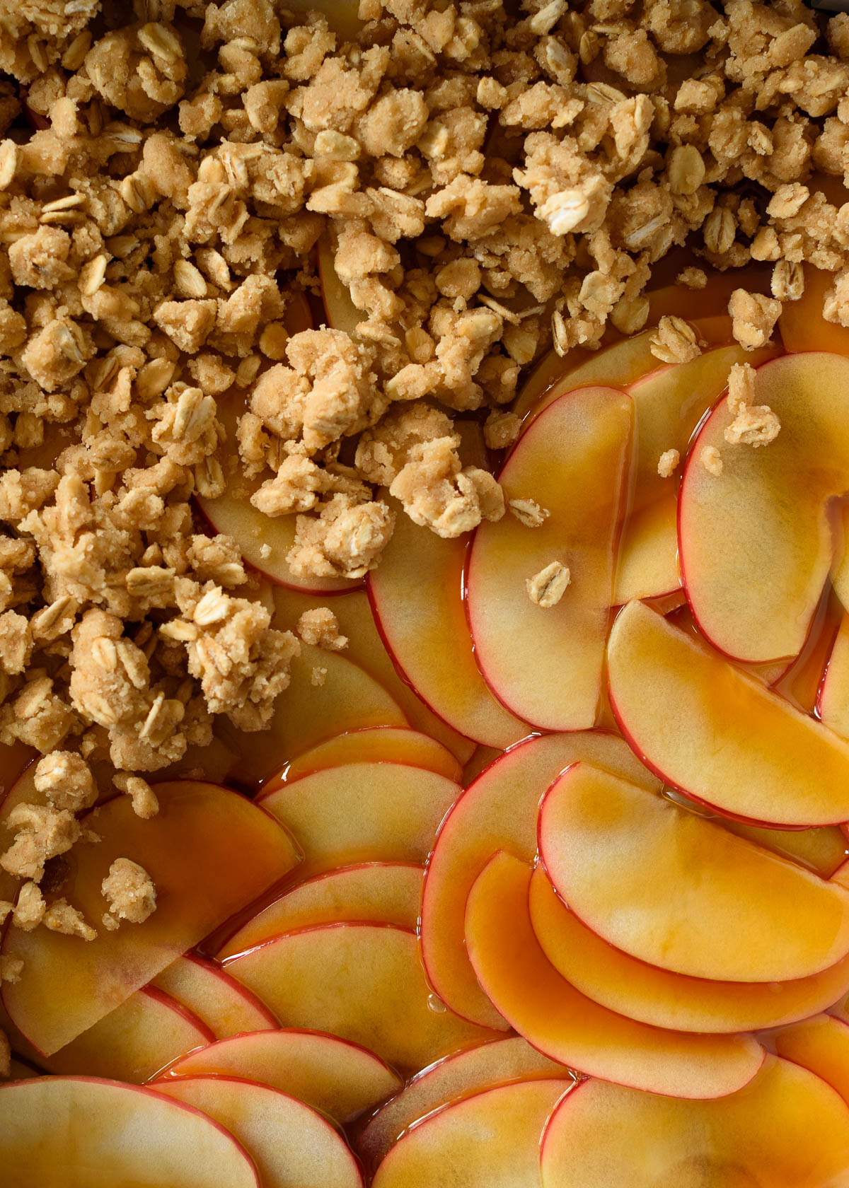 Layers of thinly sliced apples topped with caramel sauce and a brown sugar oat crumble to make apple crumb bars.