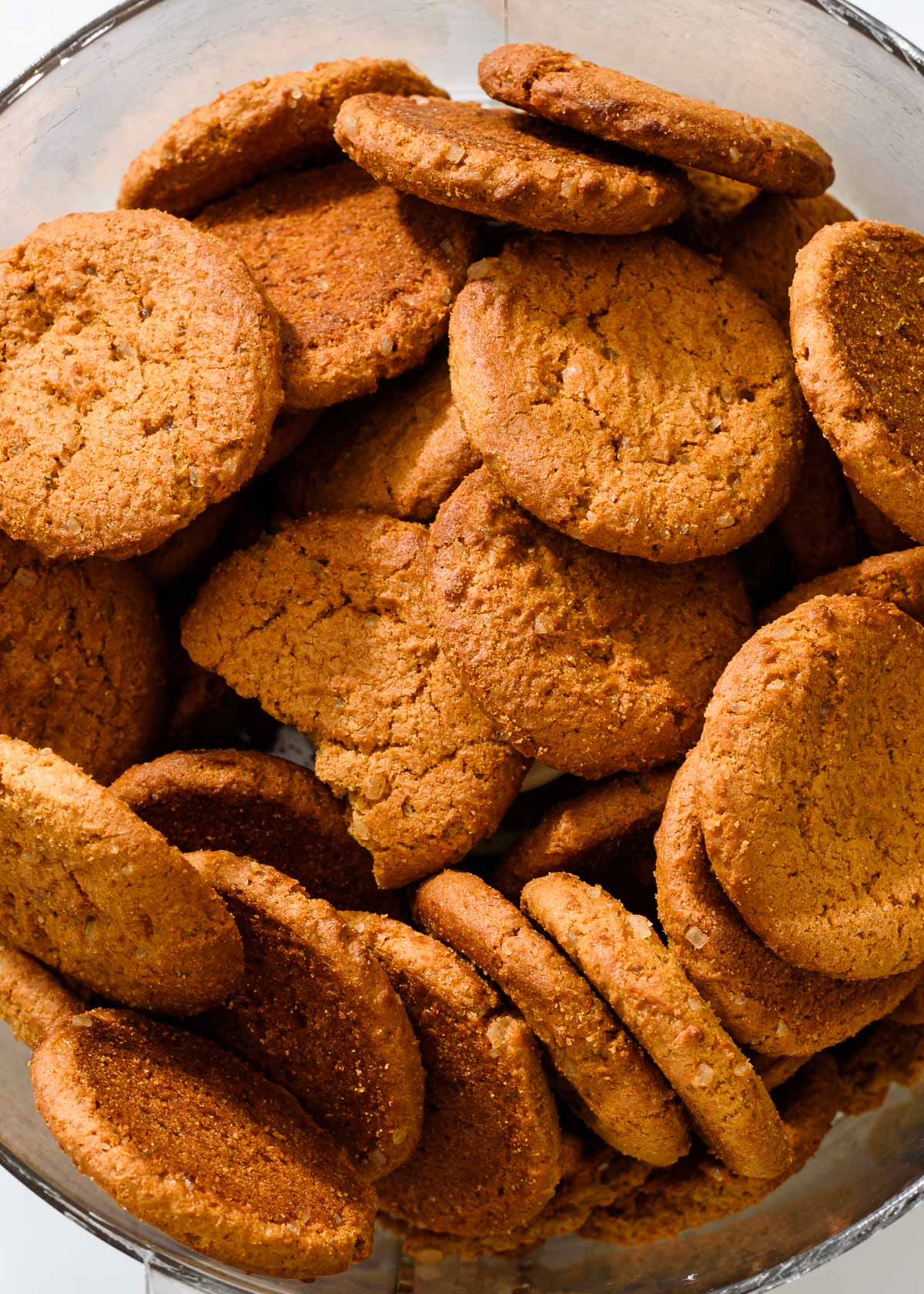 A closeup of crispy gingersnap cookies in a food processor.
