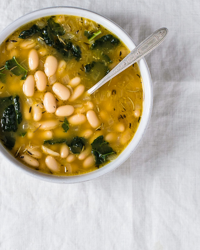 a bowl of white bean soup with kale from forkknifeswoon.com