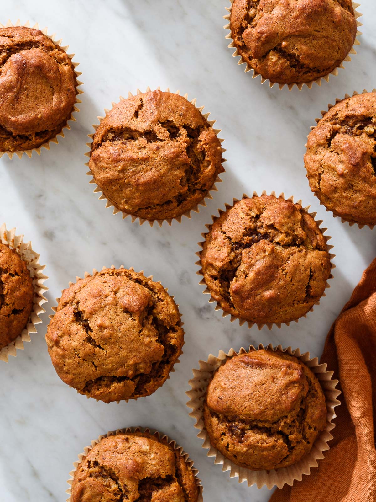 Pumpkin gingerbread muffins on a marble background.