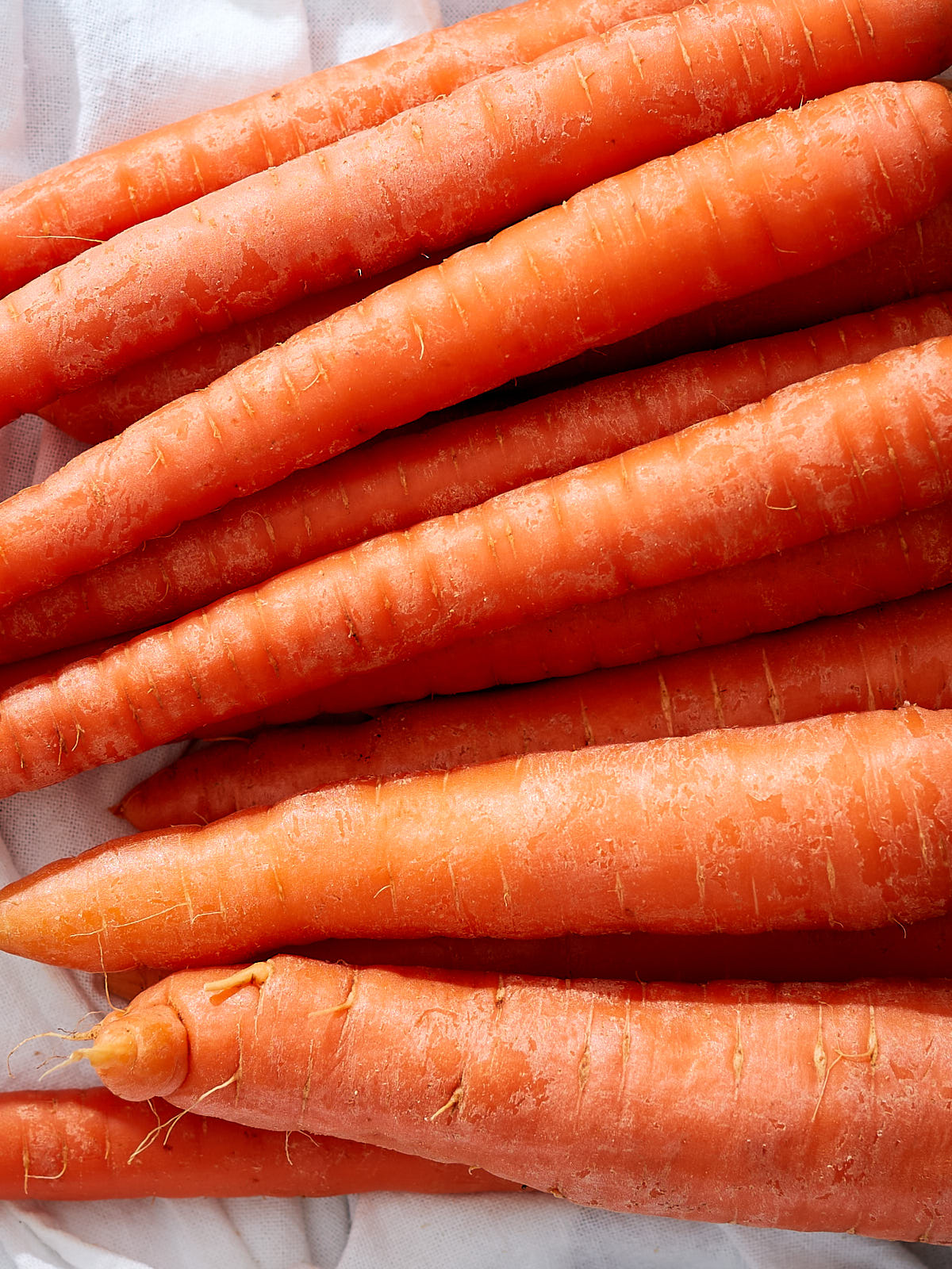 Closeup of a pile of freshly washed carrots.