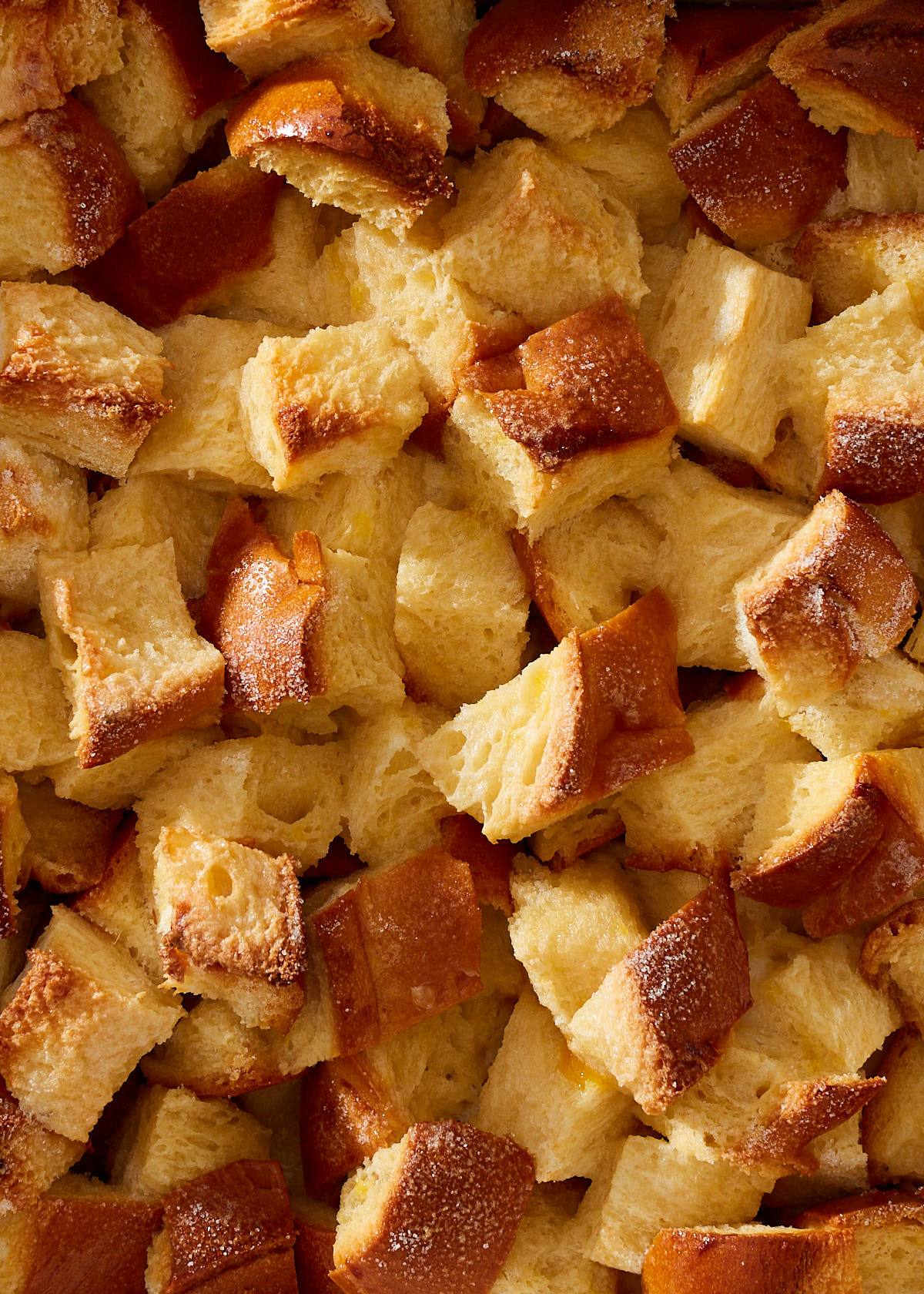 Close up of toasted cubes of brioche in bread pudding.