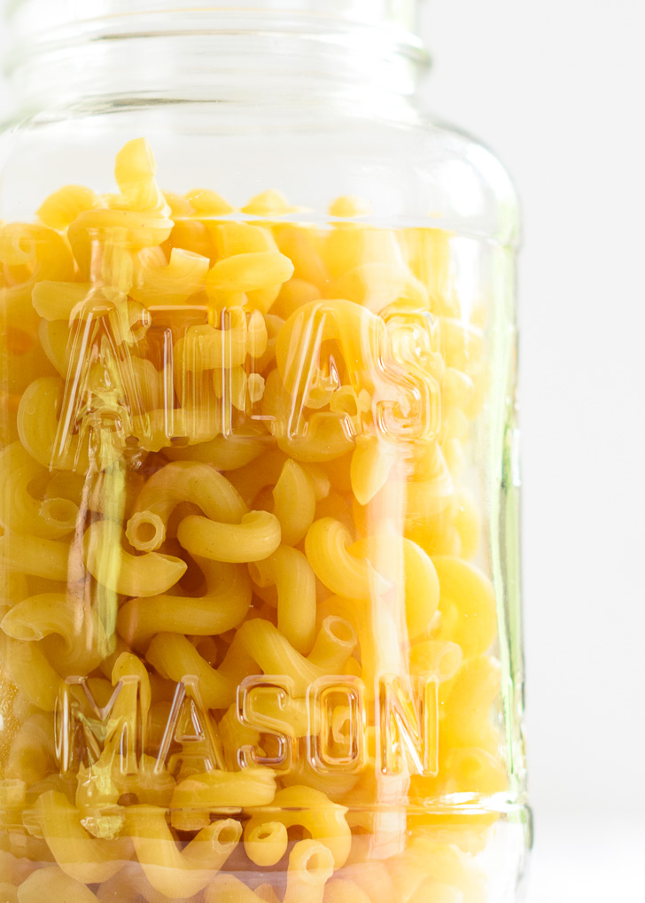 Cavatappi pasta in a glass mason jar.
